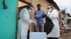 FILE - Staff members of the Ministry of Health visit residents to take samples during the first day of mass testing of the COVID-19 coronavirus in Djibouti on May 2, 2020. 