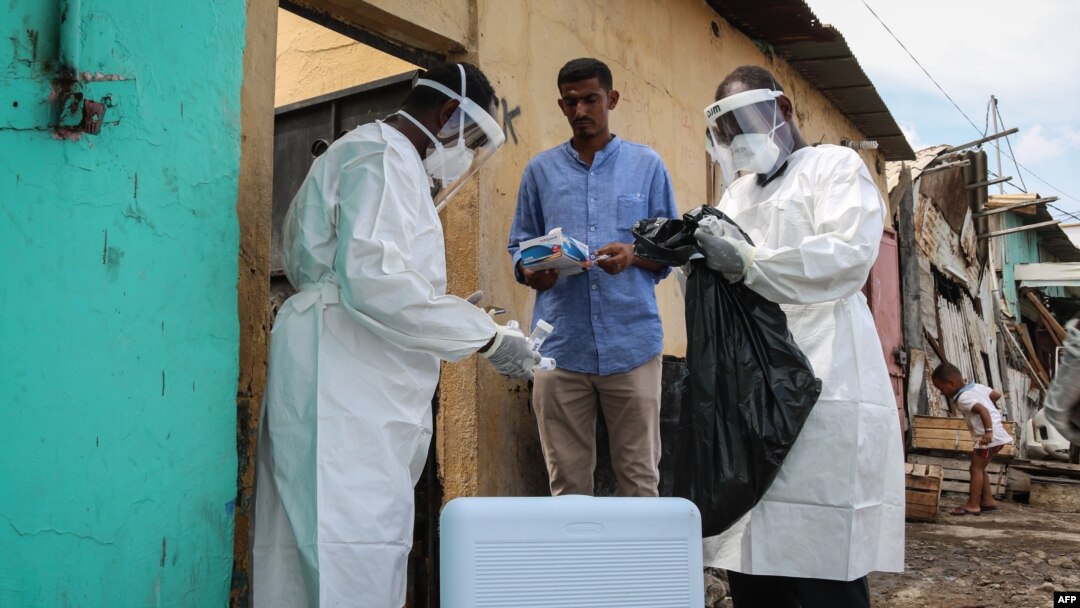 FILE - Staff members of the Ministry of Health visit residents to take samples during the first day of mass testing of the COVID-19 coronavirus in Djibouti on May 2, 2020. 