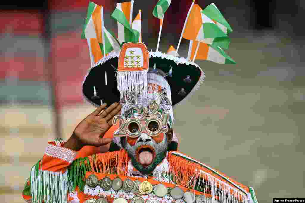 An Ivory Coast supporter cheers prior to the football match between Equatorial Guinea and Ivory Coast.