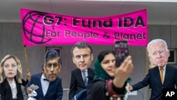 FILE—Activists urge World Bank and G7 leaders to "wake up and fund IDA" to address climate justice and debt relief concerns, outside the World Bank in Washington on April 17, 2024. 