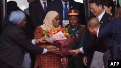 FILE - Tanzania's President Samia Suluhu Hassan, center, receives a bouquet of flowers upon her arrival at Beijing Capital International Airport in Beijing on Sept. 3, 2024, ahead of the Forum on China-Africa Cooperation.