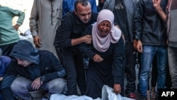 Palestinians react in front of the bodies people killed in an Israeli strike, at the al-Aqsa Martyrs Hospital in Deir Al-Balah in the central Gaza Strip on Nov. 17, 2024.