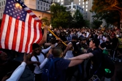 Demonstrators clash as people gather to protest the death of George Floyd, Saturday, May 30, 2020, near the White House in Washington.