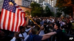 Demonstrators clash as people gather to protest the death of George Floyd, Saturday, May 30, 2020, near the White House in Washington. Protest erupted across the United States to protest the death of Floyd, a black man who was killed in police…