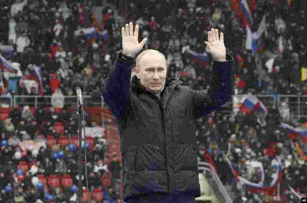 Presidential candidate and Russia's current Prime Minister Vladimir Putin waves during a rally to support his candidature in the upcoming presidential election at the Luzhniki stadium on the Defender of the Fatherland Day in Moscow, February 23, 2012.