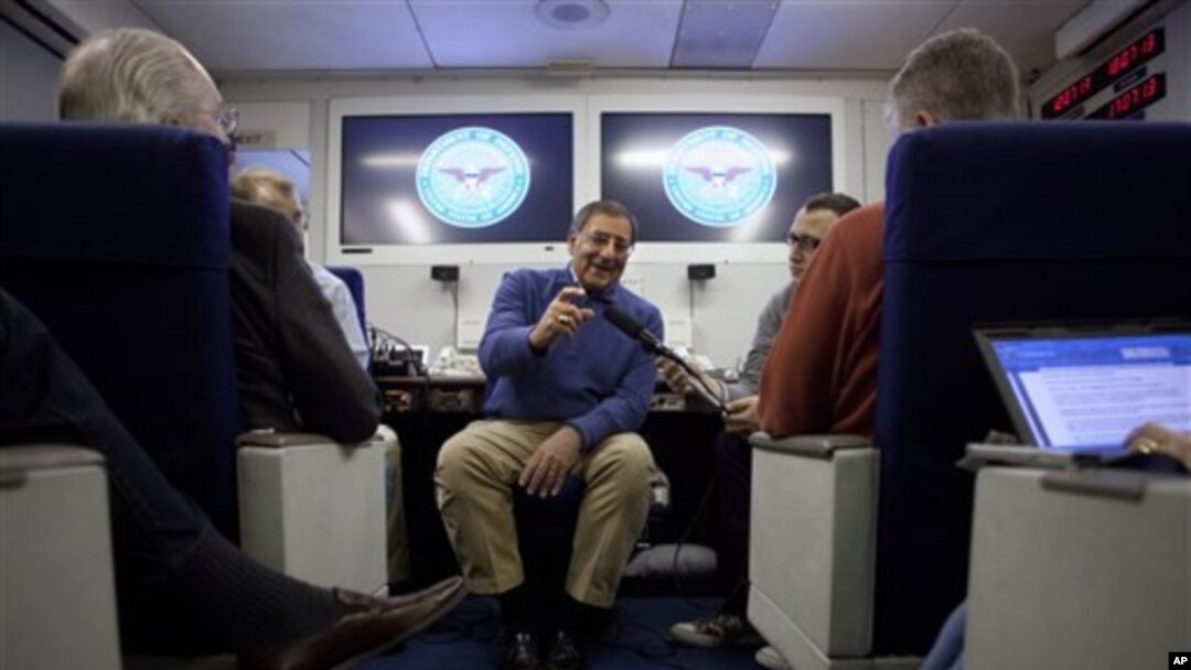 Defense Secretary Leon Panetta briefs the media on board a plane en route to a NATO conference in Brussels, Belgium, Feb. 1, 2012.