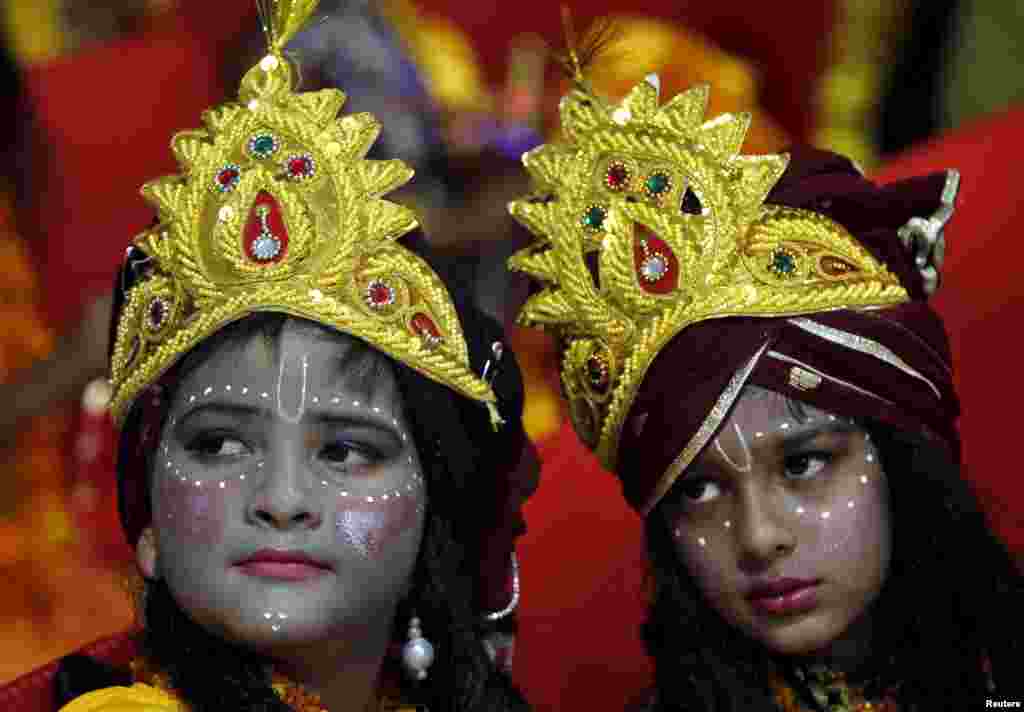 Children dressed as Hindu Lord Krishna wait to participate in a fancy dress competition at a temple in Chandigarh, India.
