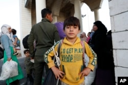 A Syrian boy is pictured as he flees the war in Lebanon with his family at the Syrian-Lebanese border crossing in Jdeidet Yabous, Syria, Sept. 25, 2024.