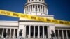 Caution tape blocks the street at the entrance of the National Capitol building in Havana, Cuba, July 13, 2021. 