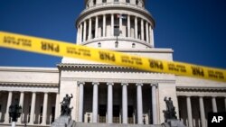 Caution tape blocks the street at the entrance of the National Capitol building in Havana, Cuba, July 13, 2021. 