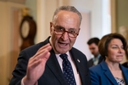 Senate Minority Leader Chuck Schumer, D-N.Y., joined at right by Sen. Amy Klobuchar, D-Minn., speaks to reporters at the Capitol in Washington, April 9, 2019.