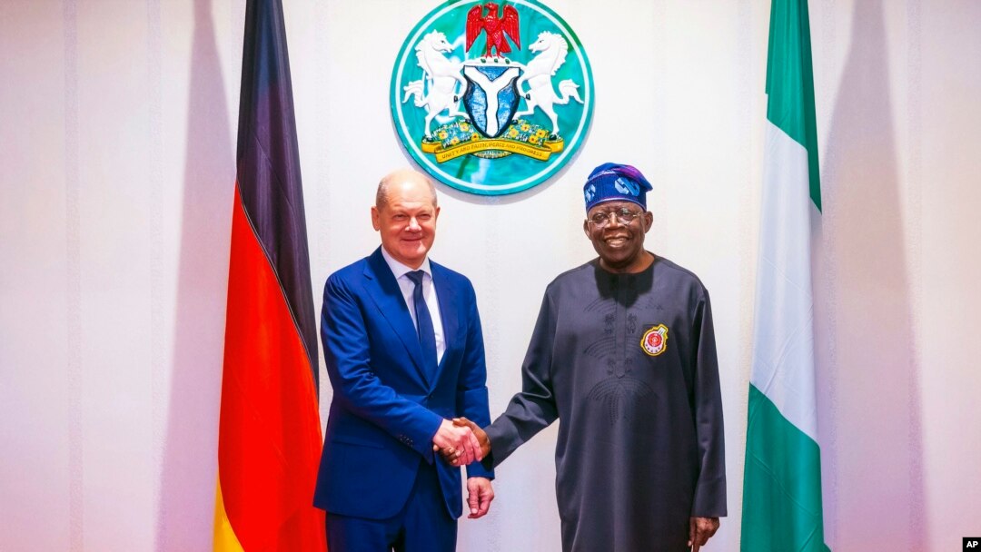 FILE - In this photo released by the Nigeria State House, German Chancellor Olaf Scholz, left, is welcomed by Nigeria's President Bola Tinubu, right, upon his arrival at the Presidential palace in Abuja, Nigeria, Sunday, Oct. 29, 2023. 