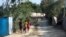Girls carry roosters down a dirt road in Jean-Rabel, Haiti, Jan. 31, 2020. 