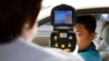 FILE - A South Korean official, left, uses a thermal camera to checks the body temperature of a driver as a precaution against Middle East Respiratory Syndrome (MERS) after he returned from Kaesong, North Korea, near Panmunjom, South Korea, June 13, 2015.