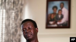 Jacob Mabil pauses during an interview at his home about his two nieces Wednesday, Nov. 8, 2023, in Haslet, Texas. Mabil is one of Sudan's "Lost Boys," and is trying to get his two nieces from African refugee camps to the U.S. to live with him and his family.