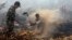 Warga desa dan anggota TNI berusaha memadamkan kebakaran hutan dan lahan di Rimbo Panjang, provinsi Riau (6/9). Presiden Jokowi memerintahkan tindakan hukum yang tegas terhadap pihak yang bertanggung jawab atas kebakaran hutan.
