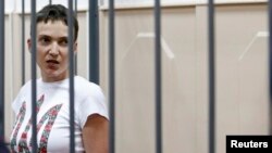 FILE - Ukrainian army pilot Nadiya Savchenko speaks inside a defendants' cage as she attends a hearing at the Basmanny district court in Moscow, Feb. 10, 2015. 