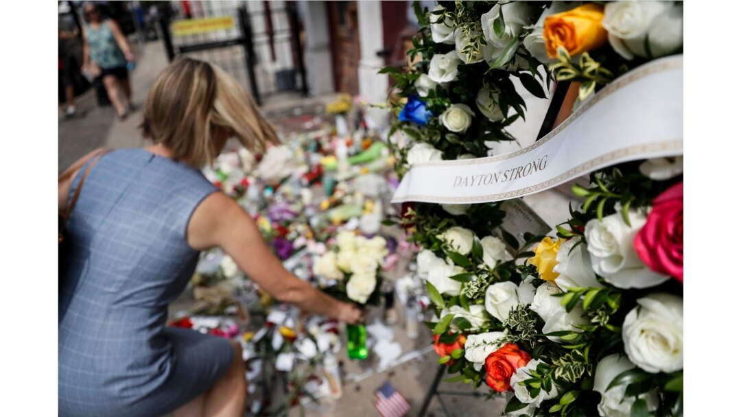 Mourners bring flowers to a makeshift memorial, Aug. 6, 2019, for the slain and injured in the Oregon District after a mass shooting that occurred Aug. 4, 2019, in Dayton, Ohio.