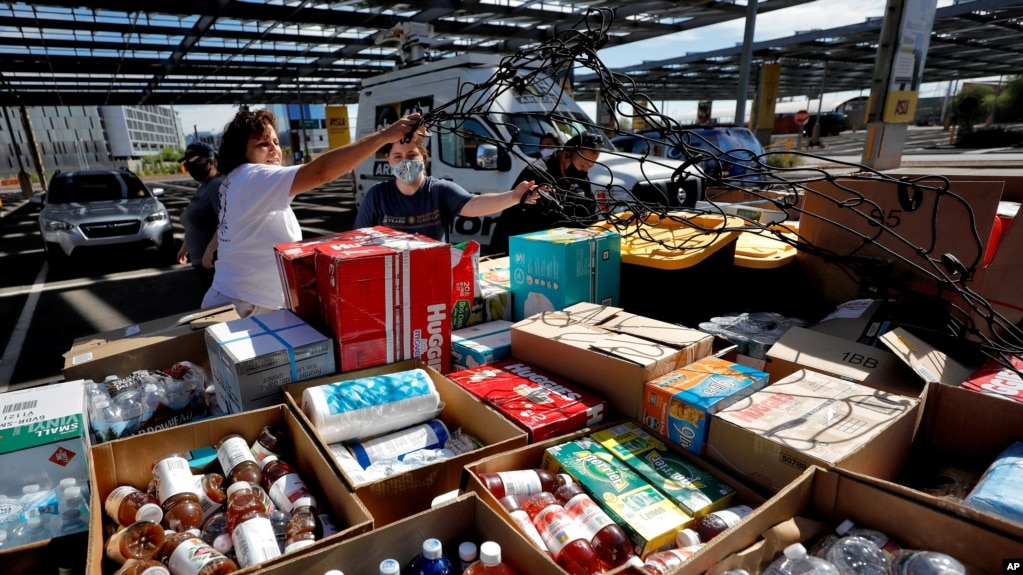 Volunteers prepare donations for delivery to those affected by COVID-19 on tribal lands on June 25, 2020, in Tempe, Ariz. 