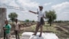 A member of the Amhara militia gives directions during a food distribution organized by the Amhara government near the village of Baker in the Tigray Region of Ethiopia, on July 11, 2021.