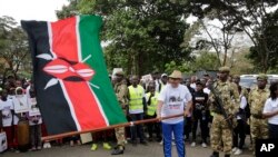 FILE - Former Cabinet Secretary for Tourism and Wildlife Najib Balala waves a Kenyan flag during a march in Nairobi, Kenya, Saturday, April 13, 2019.