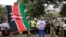 FILE - Former Cabinet Secretary for Tourism and Wildlife Najib Balala waves a Kenyan flag during a march in Nairobi, Kenya, Saturday, April 13, 2019.