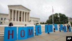 FILE - Deferred Action for Childhood Arrivals (DACA) students gather in front of the Supreme Court in Washington, June 18, 2020.