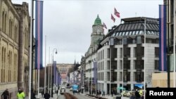 FILE - People walk on the street in Oslo, Norway, March 20, 2017. 