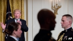 President Donald Trump speaks at a reception for senators and their spouses in the East Room of the White House, in Washington, March 28, 2017.