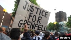 Protesters march towards The Grenfell Tower block that was destroyed by fire, in north Kensington, West London, Britain, June 16, 2017.