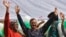 Aam Aadmi (Common Man) Party (AAP) chief and its chief ministerial candidate for Delhi, Arvind Kejriwal (C) waves to his supporters in New Delhi, February 10, 2015.