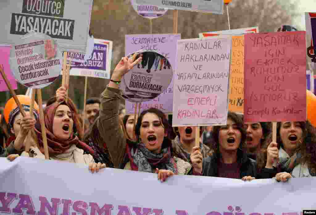 Demonstrators hold banners and shout slogans during a rally to mark International Women's Day in Ankara