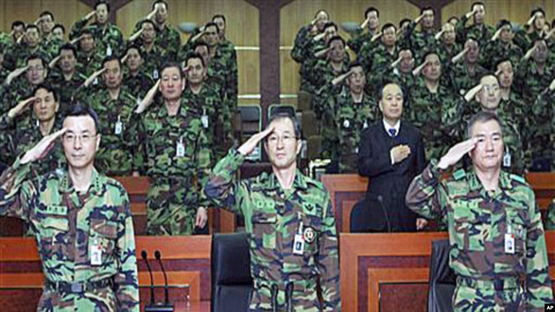 South Korea's Army Chief of Staff, Kim Sang-ki, center, salutes with other military members during the commanders meeting at the Army headquarters in Daejeon, south of Seoul, South Korea, 30 Dec 2010