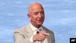 FILE - In this June 19, 2019, file photo, Amazon founder Jeff Bezos speaks during the JFK Space Summit at the John F. Kennedy Presidential Library in Boston. Bezos is one of the 50 Americans who gave the most to charity in 2020. 