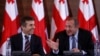 Georgia's president-elect Giorgi Margvelashvili (R) and Prime Minister Bidzina Ivanishvili are seen at a news conference in Tbilisi October 28, 2013.