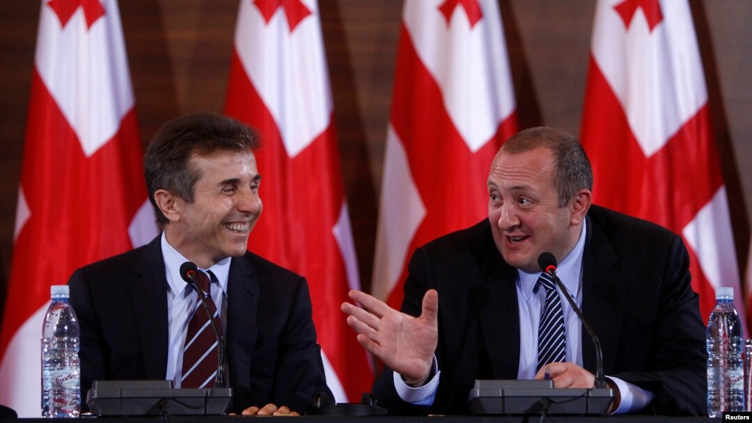 Georgia's president-elect Giorgi Margvelashvili (R) and Prime Minister Bidzina Ivanishvili are seen at a news conference in Tbilisi October 28, 2013.