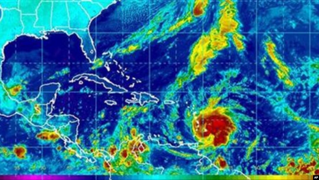 This image provided by NOAA shows Tropical Storm Tomas, lower center, taken early Saturday morning 30 Oct 2010