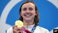 Katie Ledecky of the United States poses with her gold medal after winning the women's 1500-meters freestyle final at the 2020 Summer Olympics, July 28, 2021, in Tokyo, Japan. 