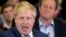 FILE - With then-British Prime Minister David Cameron in the background, Boris Johnson, then London's mayor, speaks at a campaign rally for a Conservative mayoral candidate in London, May 3, 2016. Johnson is new PM Theresa May's pick to be foreign minister.