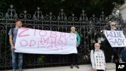 Protesters with banners calling on Justice Minister Zbigniew Ziobro to quit over allegations that his deputy encouraged an online hate campaign against defiant judges in Warsaw, Poland, Aug. 21, 2019. 