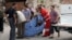 Syrian men carry body at scene of four explosions at Saadallah al-Jabri square, Aleppo, Oct. 3, 2012.