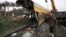 Egyptians railway workers attempt to remove debris from tracks following a train crash in Badrasheen, 40 KM south of Cairo, Egypt, January 15, 2013.