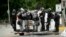 Police officers ride on the side of a van as right-wing demonstrators and counterprotesters gather in Portland, Ore., for an "End Domestic Terrorism" rally, Aug. 17, 2019. 