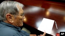 Noth Korea Detained AmericanIn this photo released by the Korean Central News Agency Nov. 30, 2013, U.S. citizen Merrill Newman, 85, applies his thumb print to a document North Korean authorities say was an apology Newman wrote and read in North Korea, No