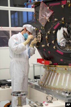 In this photo provided by ispace in April 2023, a technician works on the Hakuto spacecraft in Japan.