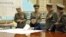 North Korea's official Korean Central News Agency on March 29, 2013 shows, according to KCNA, North Korean leader Kim Jong Un discussing the strike plan with North Korean officers during an urgent operation meeting at the Supreme Command in an undisclosed location. (Courtesy - AFP Photo/KCNA VIA KNS)