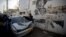 Palestinians look at a car used in an attempted ramming attack on Israeli soldiers in the Qalandia refugee camp on the outskirts of the West Bank city of Ramallah, Dec. 16, 2015. 