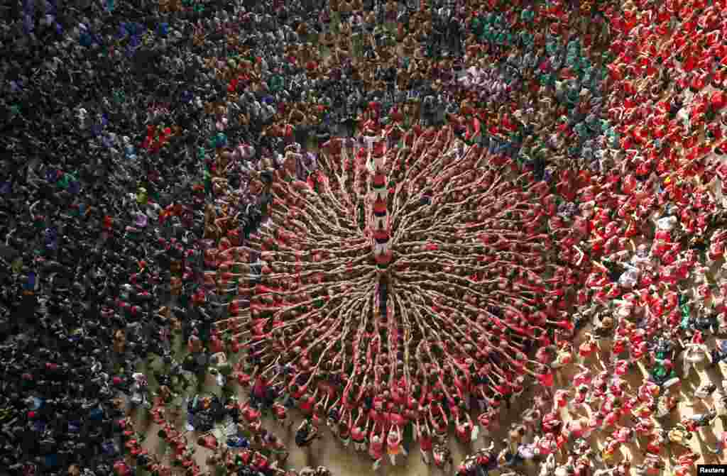 Castellers Colla Vella Xiquets de Valls form a human tower called "castell" during a biannual competition in Tarragona city, Spain.