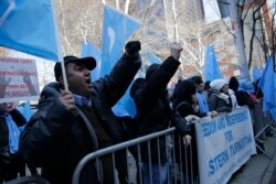 FILE - Uighurs and their supporters protest in front of the Permanent Mission of China to the United Nations in New York, March 15, 2018.