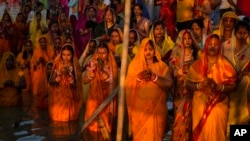 Hindu devotees gather by the river Brahmaputra and offer prayers to the setting sun during Chhath festival in Guwahati, northeastern Assam state, India, Nov. 7, 2024. 